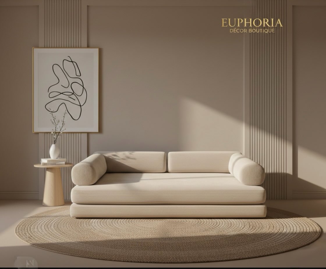 A cream corduroy sofa against a panelled taupe wall — Euphoria Déco.