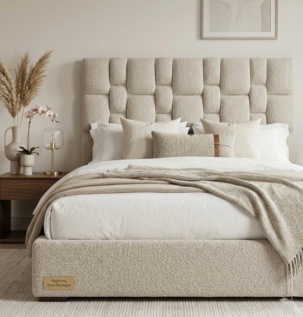 A bouclé bed with a quilted headboard, dressed in linen — Euphoria Déco bedroom.